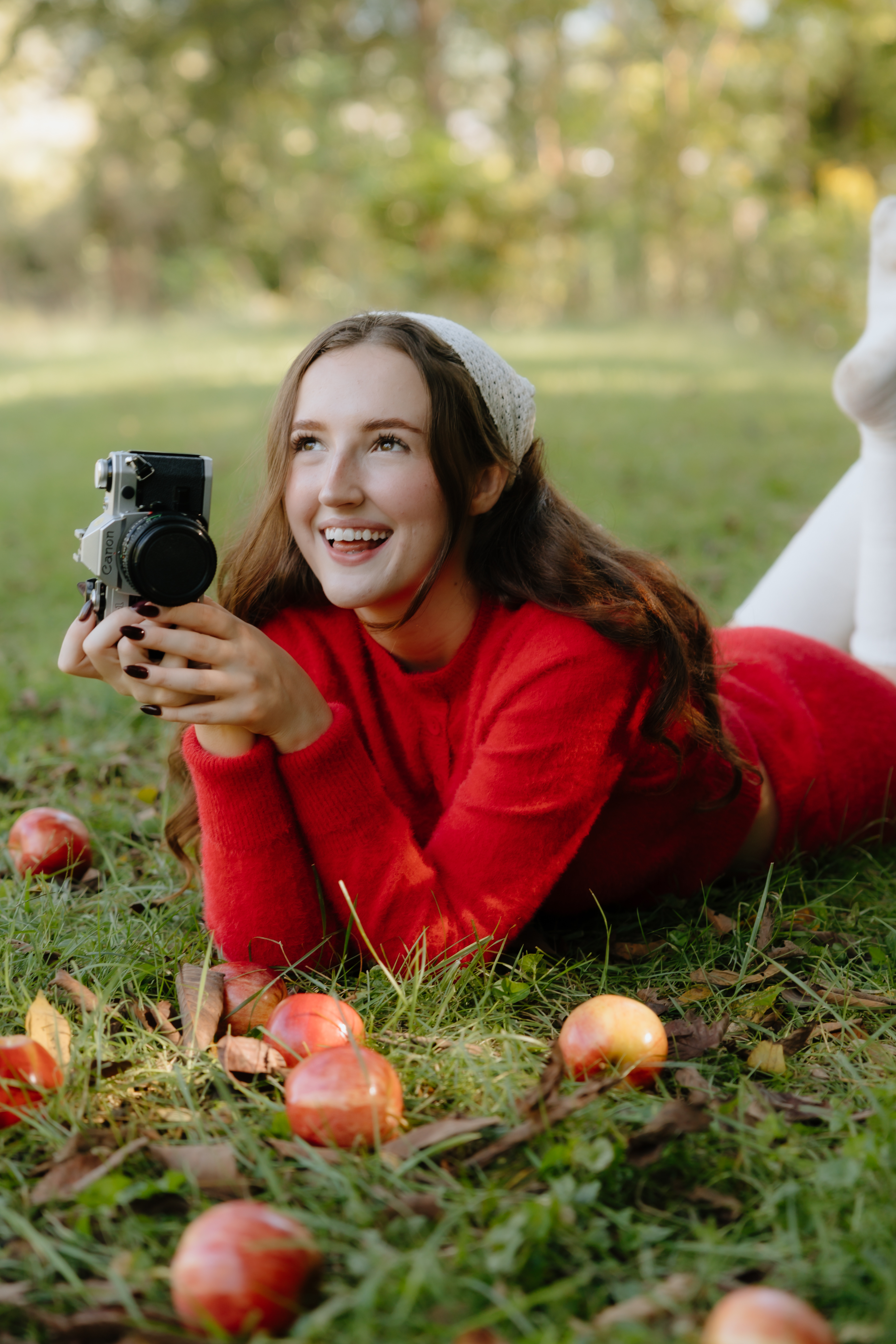 Chloe Sanderson holding a camera outdoors
